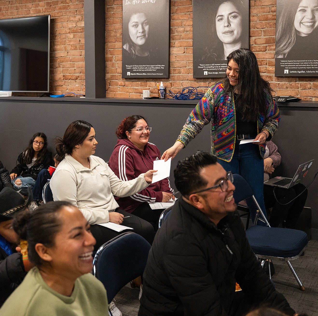 Itzel Chavez Gomez hands out papers at a meeting