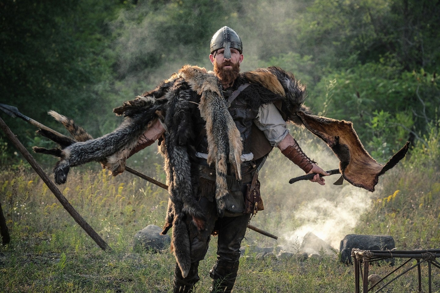 Thorfinn, in full battle gear, looks menacingly in an open setting