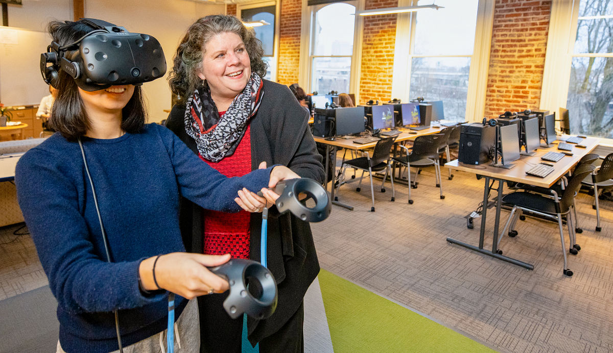 Teacher student with VR goggles