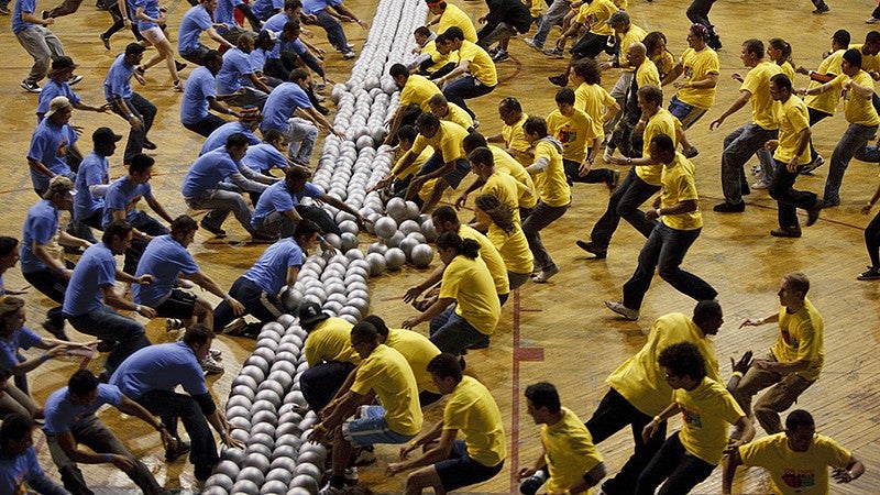 Competitors from opposing teams rushing to get dodgeballs