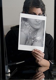 Artwork title "Time" portrays a person holding a photo over their face