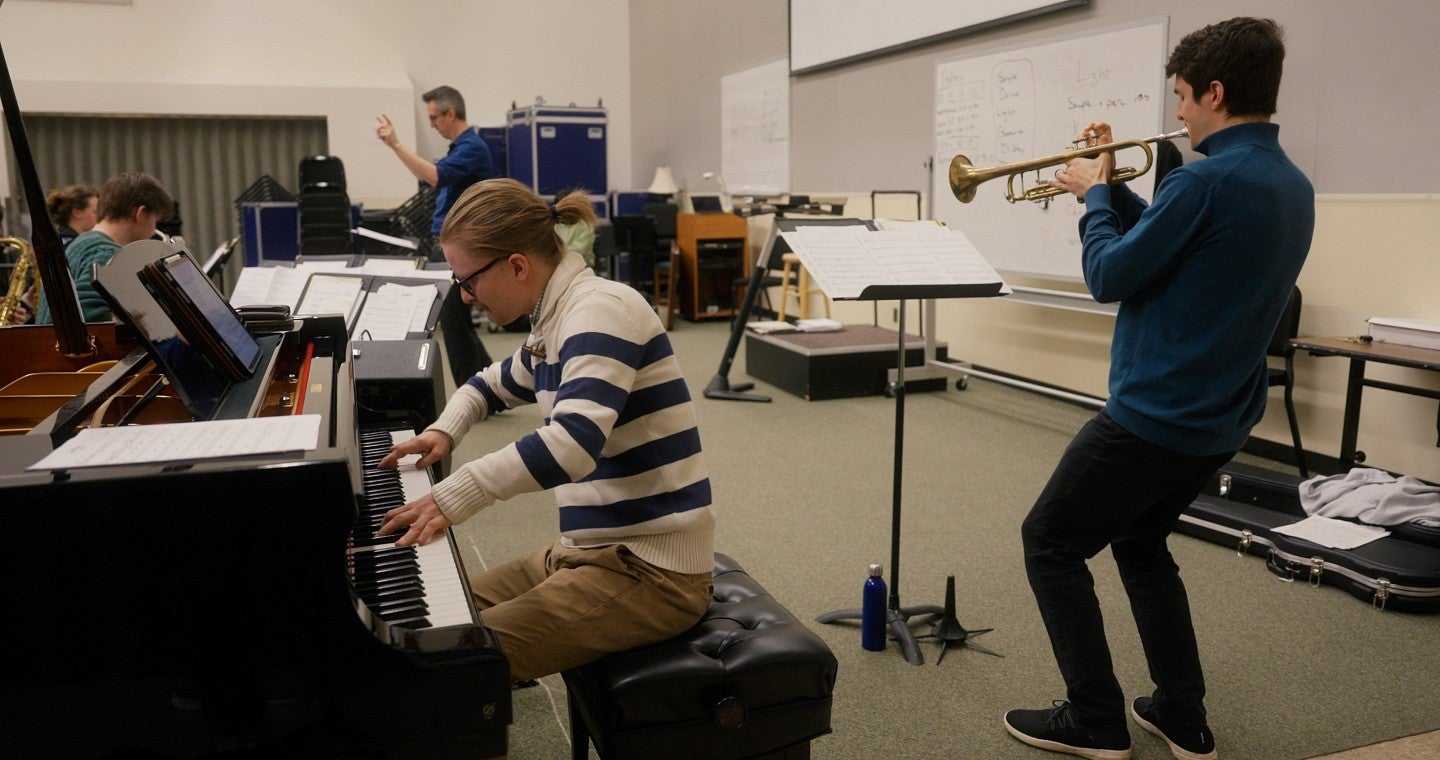 trumpet player and pianist rehearsing