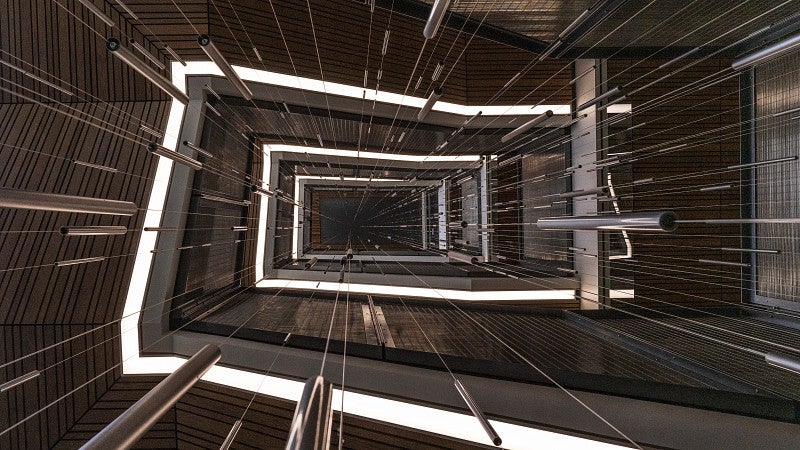 Wilkes photograph of spiraling staircase with dynamic lighting and suspended sculptures