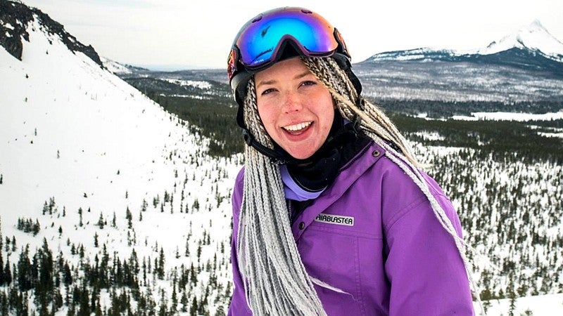 Ellie Bartlett wearing helmet and goggles on snowy mountain