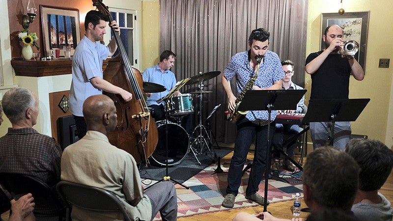 Jazz musicians perform for small audience