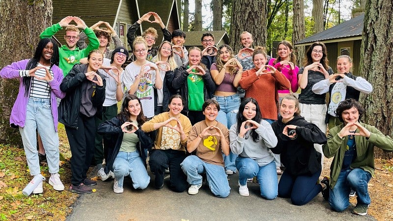 Group of UO students in woodsy setting