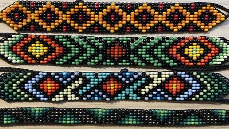 Four colorful bead bracelets with beads of orange, black, yellow, blue and green