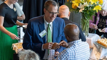 President Scholz talking with a person at an event