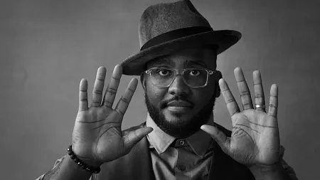 Keith Brown wearing hat and showing his hands