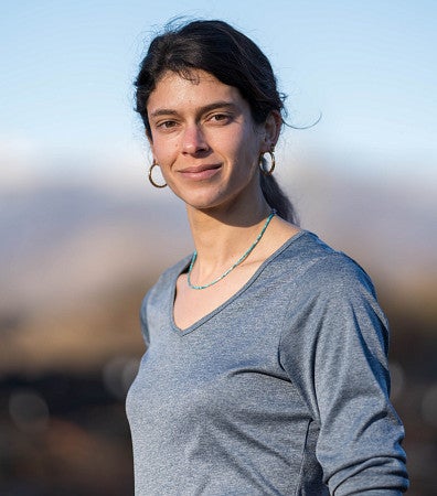 Portrait of Lauren Ponisio against a hilly landscape