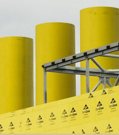 Not Mellow Yellow: image of yellow industrial building with large chimneys