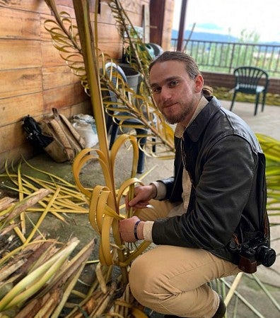 Rowan Glass weaves palm stalks to help build a "castle" for the festival