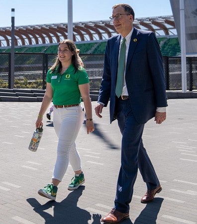 President Scholz walks with Chloe Webster, ASUO president, near Hayward Field