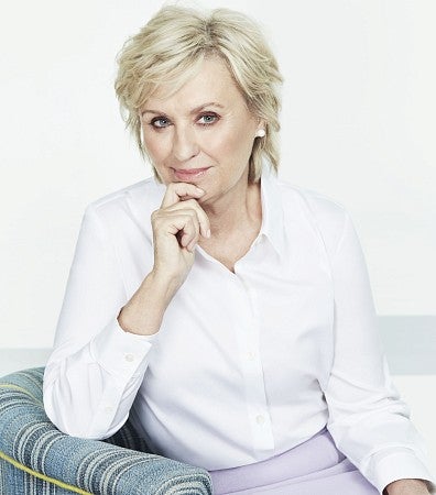 Tina Brown, sitting on a chair, introspective