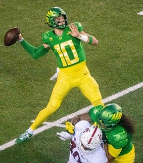 University of Oregon quarterback throws football