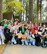 Group of UO students in woodsy setting