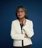 Anita Hill, in white jacket, says the promise of feminism is the unification of various marginalized groups