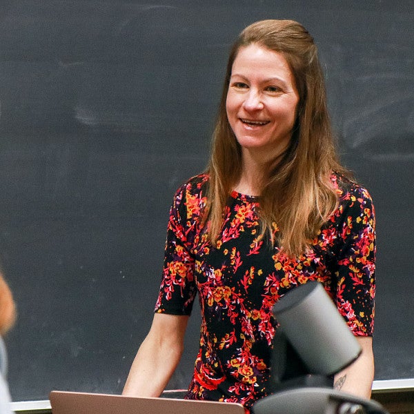 Professor Whitney Phillips at a blackboard with student in foreground