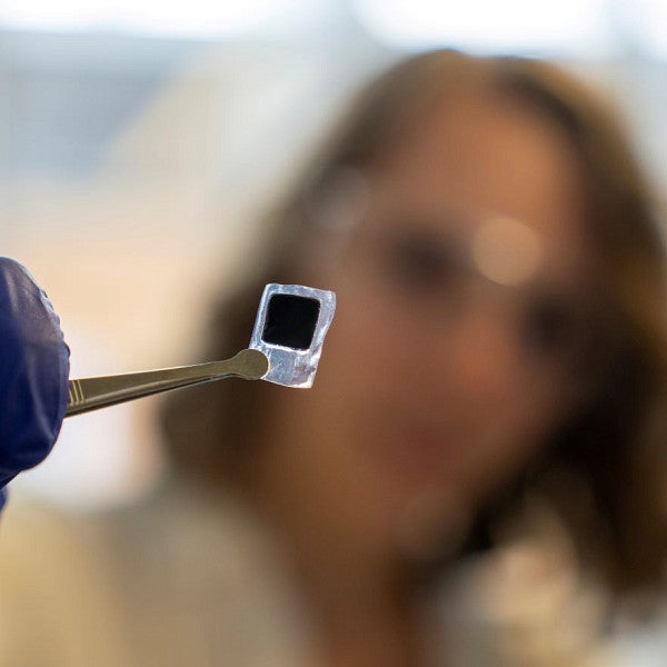 Close-up of student in lab with computer chip