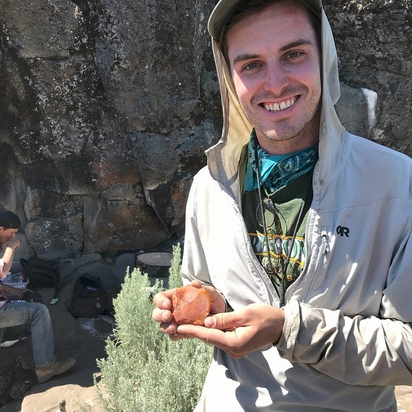 student holding dig tool